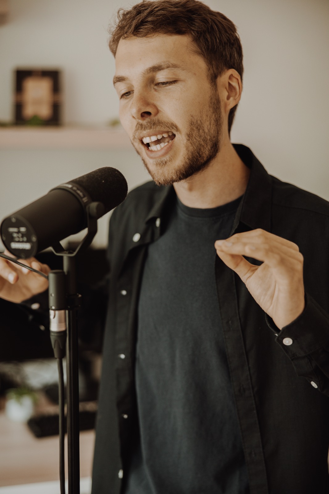 Heinz at the microphone, in the middle of a recording, eyes almost closed.